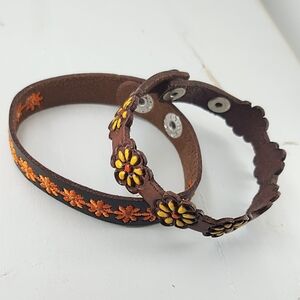 Two leather daisy snap on wrist bands